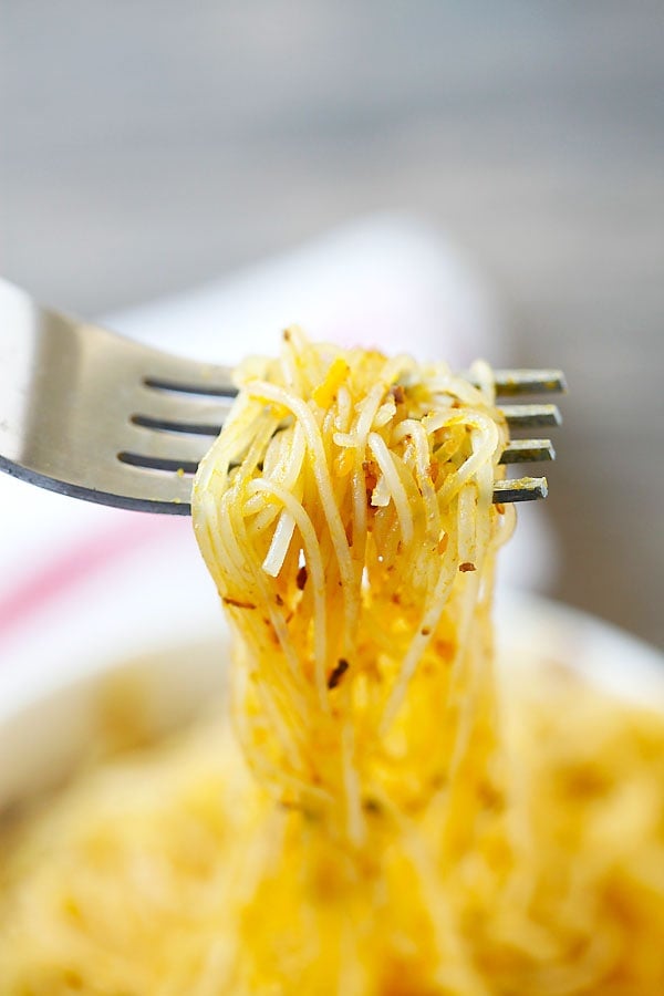 Asian stir fry Pumpkin Rice Noodles picked with a fork.