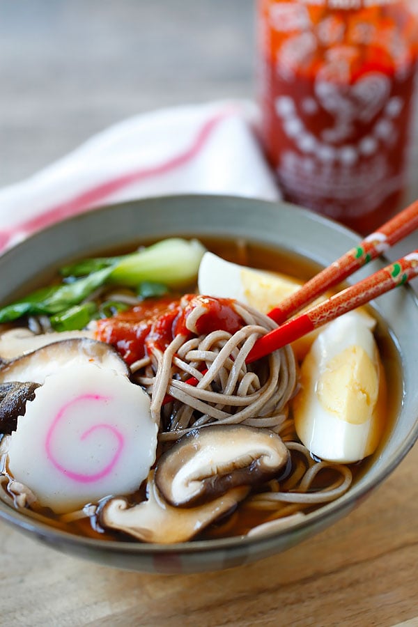 Japanese soba noodles with spicy Sriracha broth in a bowl.