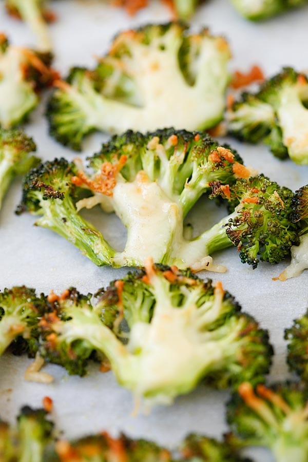 Easy oven roasted broccoli with Parmesan cheese on parchment paper.