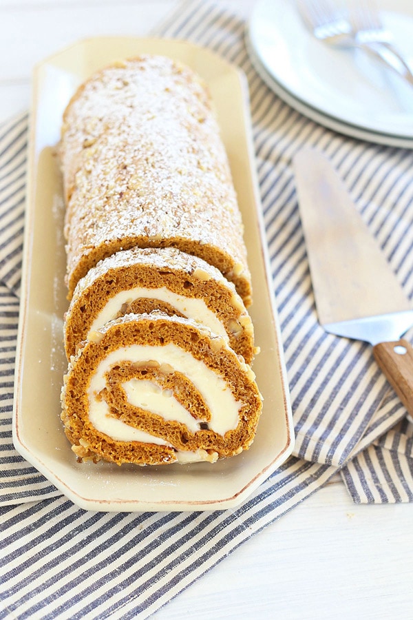 Easy and delicious Pumpkin Roll topped with walnuts with sweet cream cheese filling.
