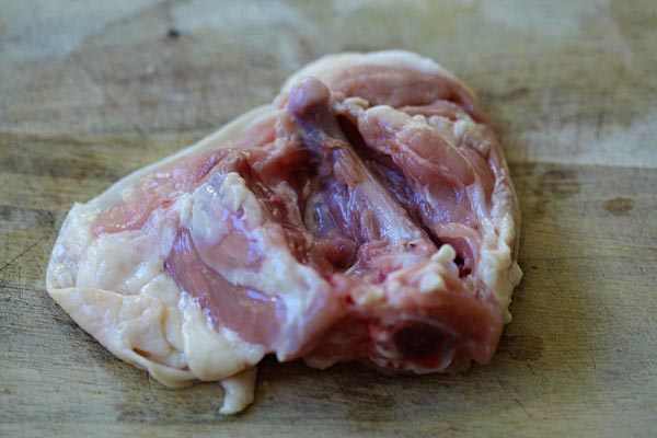 Learn the easy step-by-step to debone chicken thighs so you keep the skin on, but with no bones | rasamalaysia.com