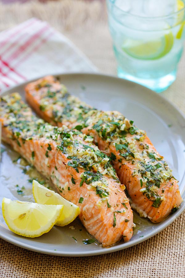 Easy and quick Garlic Herb Roasted Salmon marinade with butter, garlic, herb and lemon in a plate.