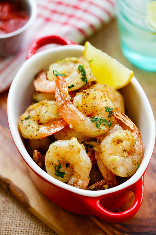 Easy and quick roasted shrimp with butter, garlic, herb and serve with cocktail sauce in serving dish.