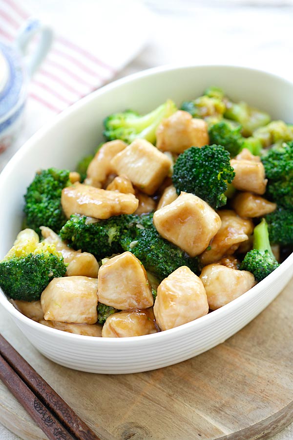 Healthy chicken and broccoli recipe cooking in brown sauce in skillet.