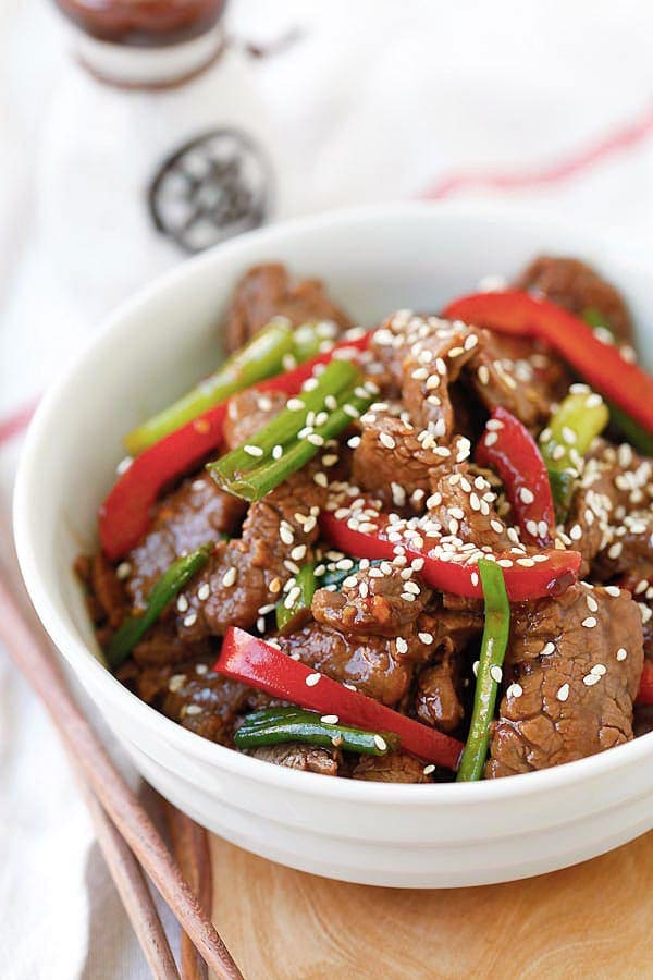Asian stir-dry sesame Beef in brown sauce in a bowl.
