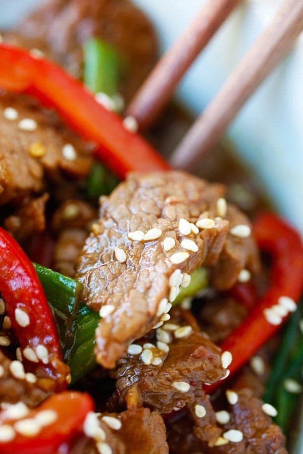 Beef stir-fry in Asian soy brown sauce garnished with sesame seeds.