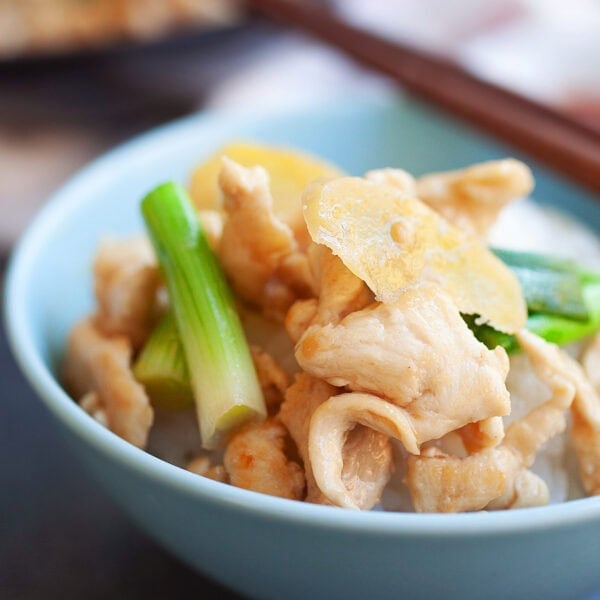 Ginger scallion chicken stir fry served in a bowl with steamed rice.