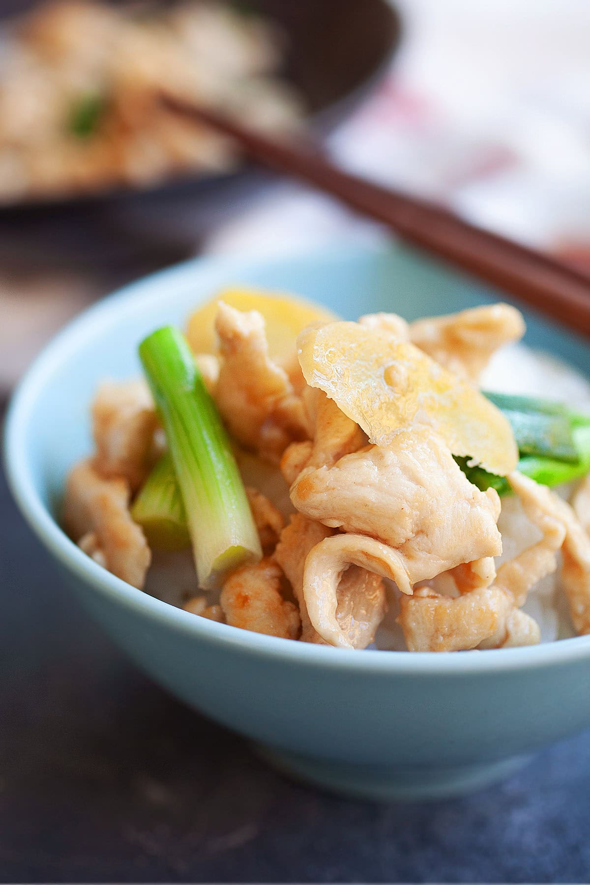 Ginger scallion chicken stir fry with sauce served in a bowl. 