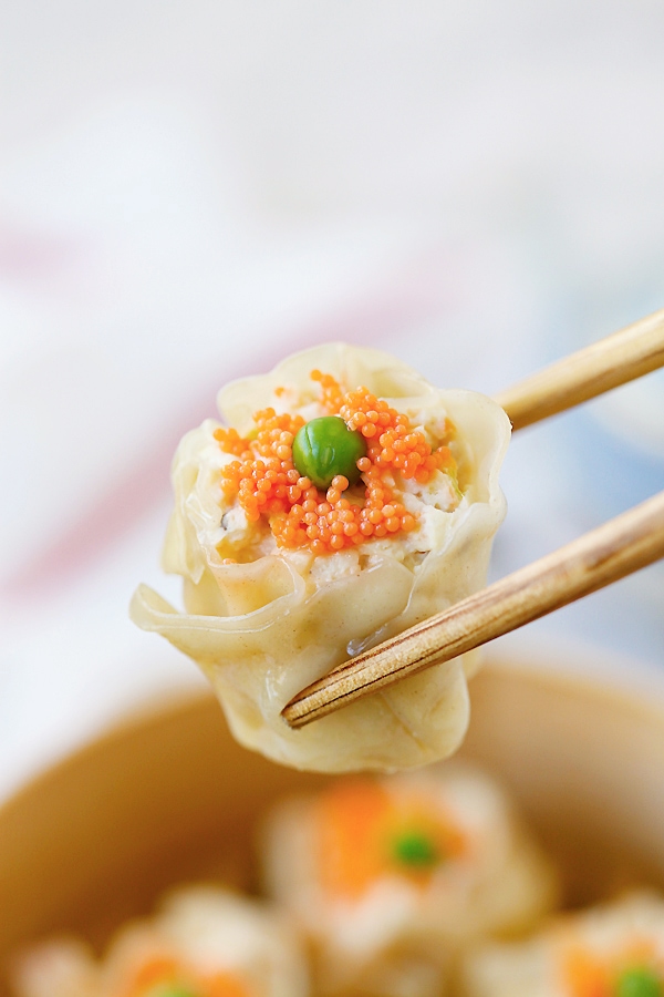 Siu Mai on chopsticks ready to eat.