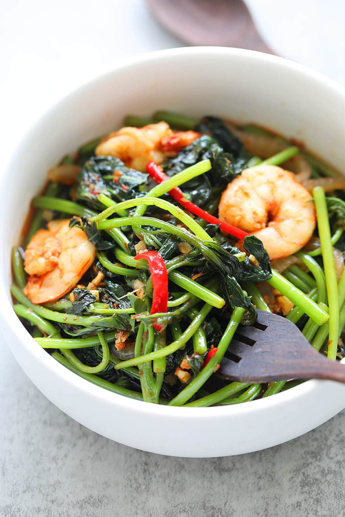 Stir fry sambal sweet potato leaves served with a fork. 