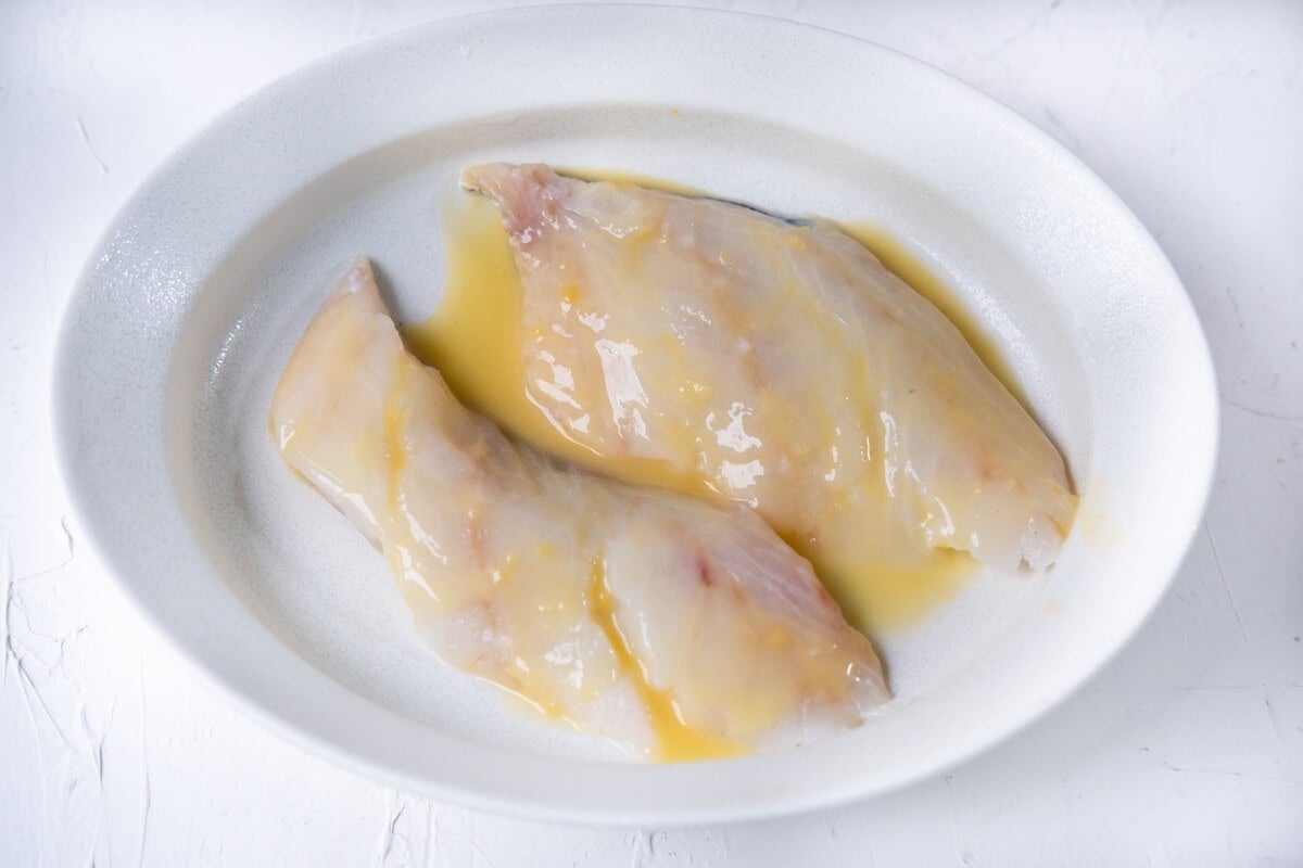 Coat the sea bass with the marinade in a small bowl. 
