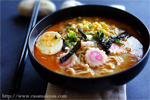 Spicy Miso Ramen with hard boiled egg, seaweed and Japanese fishcake in bowl with chopsticks to the side