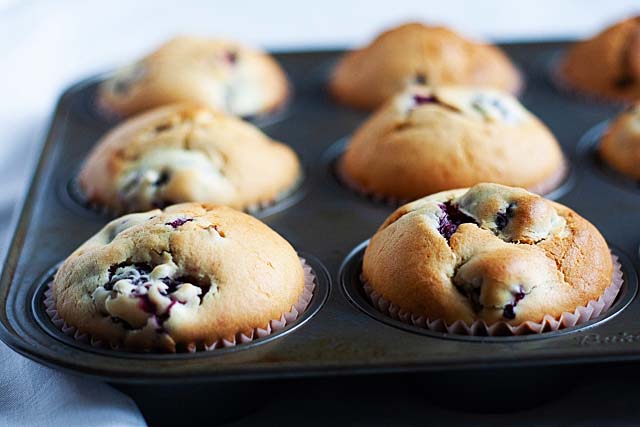 Blueberry muffins on a muffin tin.