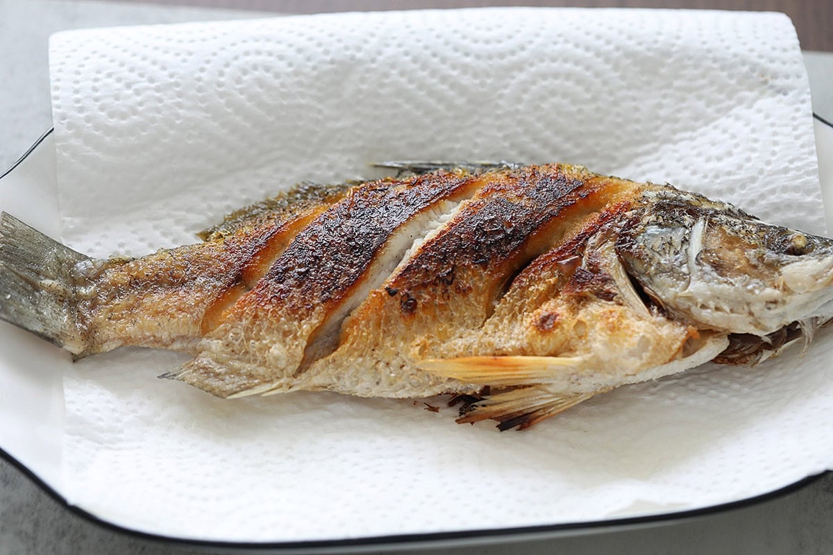 Deep fried whole fish on a plate. 