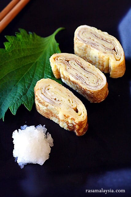 Tamagoyaki is a slightly sweet, delicious, and delicate omelet that is often packed into Japanese bento boxes and also served at sushi bars as tamago nigiri | rasamalaysia.com