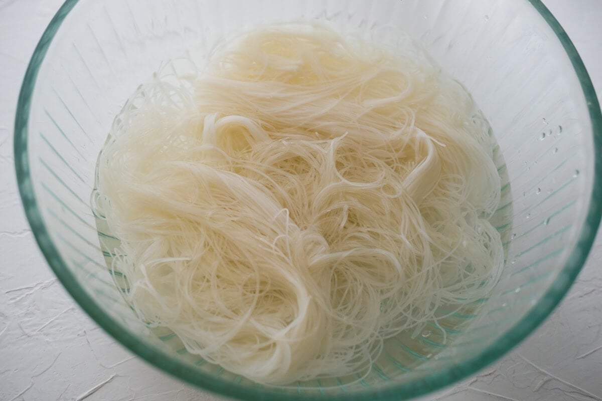 Rice vermicelli noodles soaked in a bowl of water. 