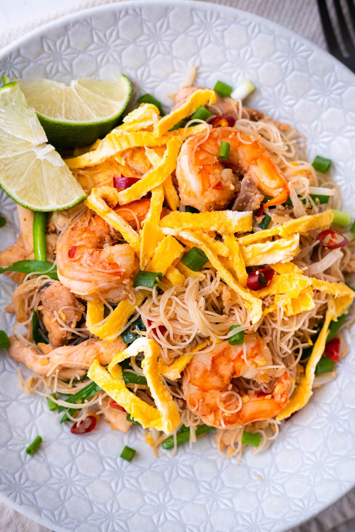 Malaysia mee siam served with shredded omelet and lime. 