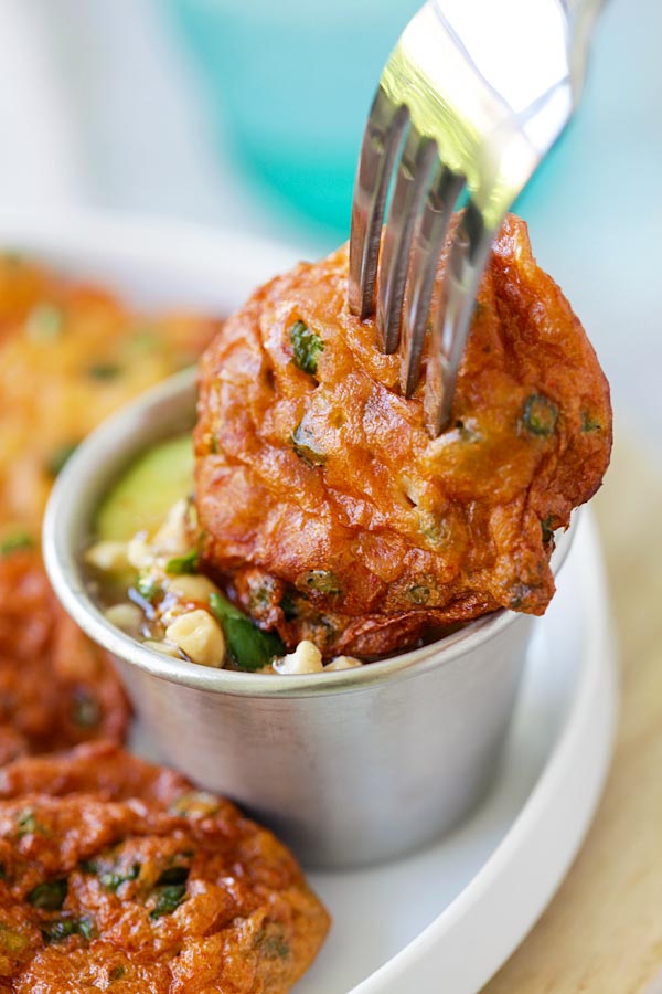 Thai fish cakes or Tod Mun Pla poked with a fork and dipped into homemade Thai dipping sauce.