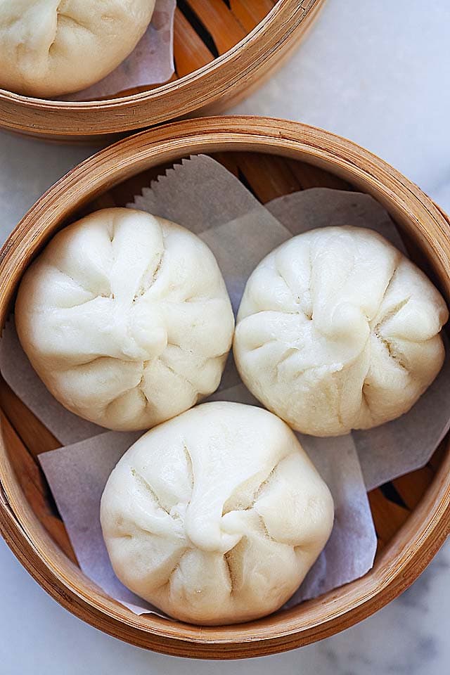 Chicken steamed buns, served in a dim sum bamboo basket.