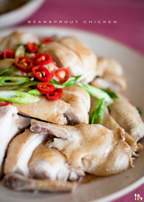 Ipoh Bean Sprout Chicken (芽菜鸡) recipe - The chicken is poached in a water bath then quickly dunk into cold water to stop the cooking process to retain its juicy smoothness texture. The bean sprouts will only need to be blanched no more than 10 seconds, then drizzle with sesame oil and soy sauce, and a smidge of white pepper for bit of kick. | rasamalaysia.com