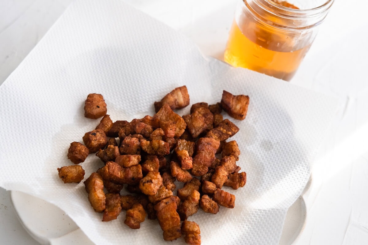 Crispy pork lard resting on a paper towel.