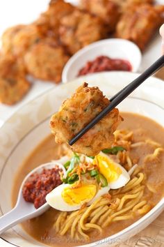 Mee rebus is one of the popular noodles dishes in Malaysia. This mee rebus recipe womes with yellow noodles in a spicy potato-based gravy and prawn fritters. | rasamalaysia.com