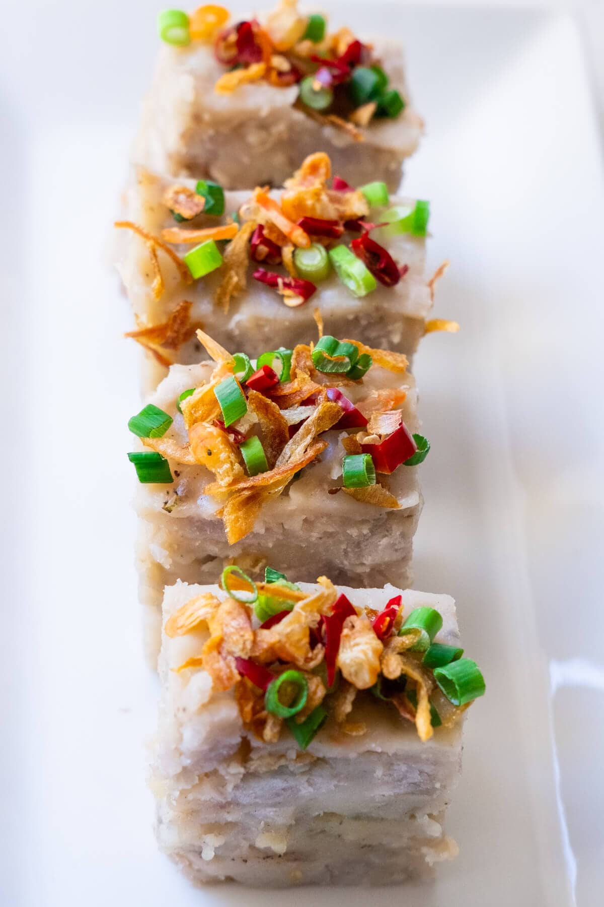 Yam cake topped with red chillies, fried shallots, dried shrimp and spring onions. 