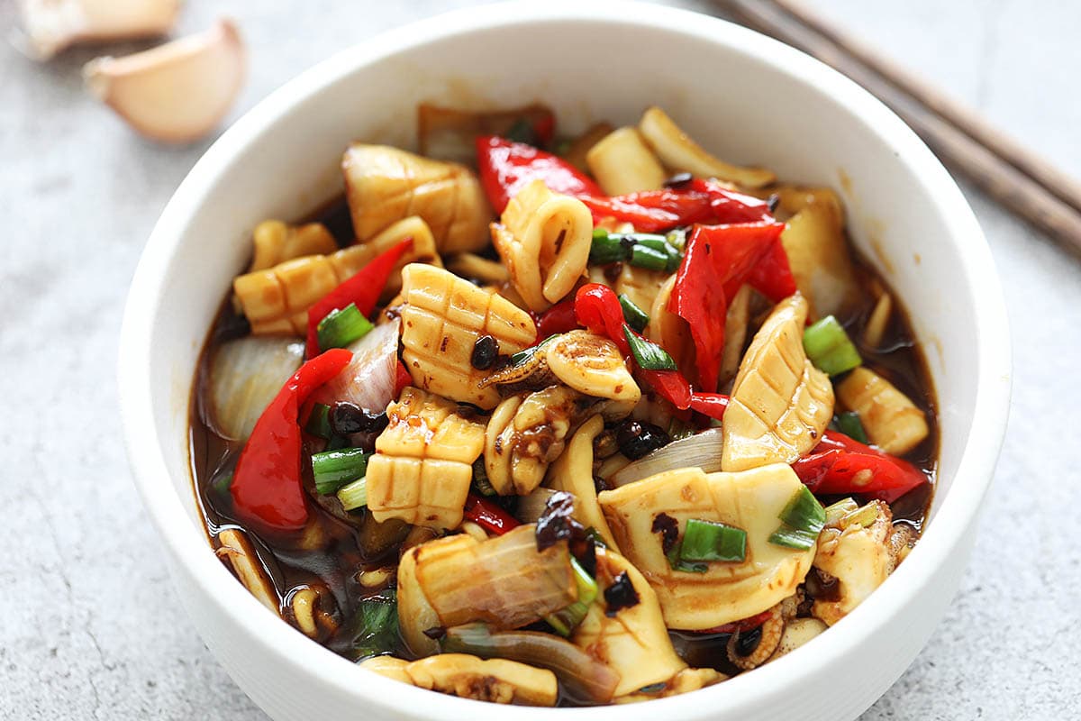 Stir fry squid in black bean sauce served on a plate.