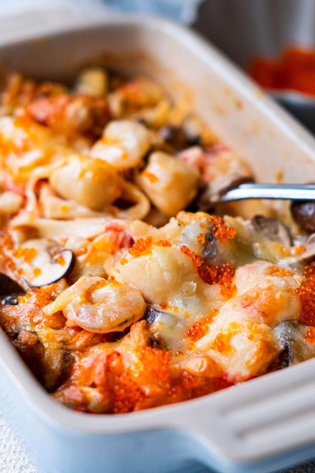 Baked seafood dynamite served in an oven-safe dish.