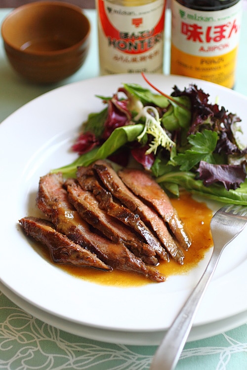 Grilled flank steak on a plate.