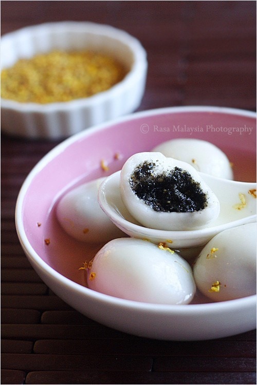 Easy and quick homemade black sesame tang yuan in half picked with a spoon.