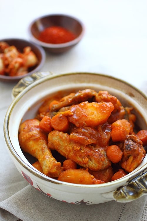Easy homemade Korean spicy chicken stew coated with red sauce in a serving dish.