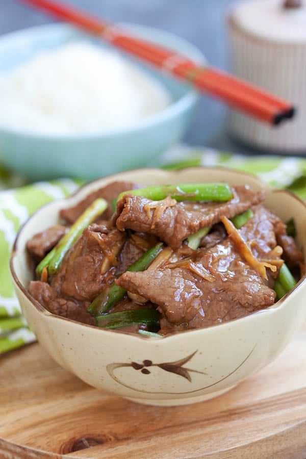 Easy and delicious Asian stir fry beef with scallion and ginger in brown sauce, served in a bowl.