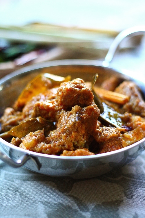 Easy and delicious homemade slow cooked Malaysian lamb rendang stew served in a skillet.