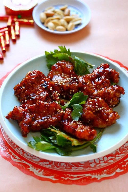 Delicious Chinese style Peking pork chop in red glaze and garnished with sesame seeds.