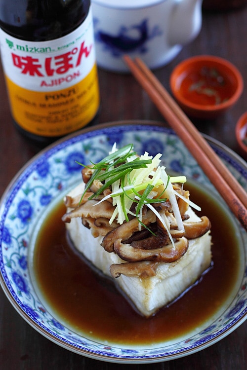 Chinese steamed fish in dark sauce topped with mushrooms and ginger.