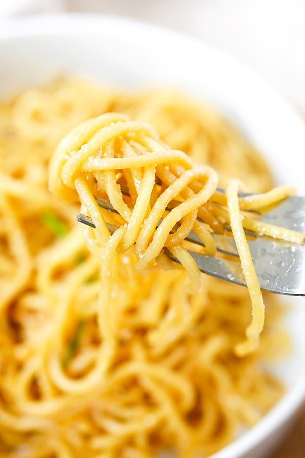 Strand of noodles in a fork ready to serve.