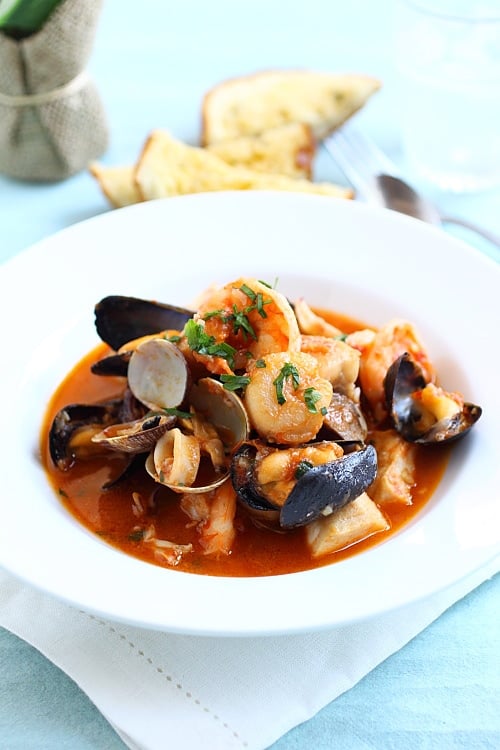 Easy and quick one-pot seafood Cioppino with shrimp, mussels and scallops in tomato-based cioppino sauce.