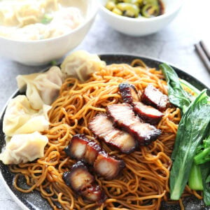 Wonton noodles with dark sauce on a plate.