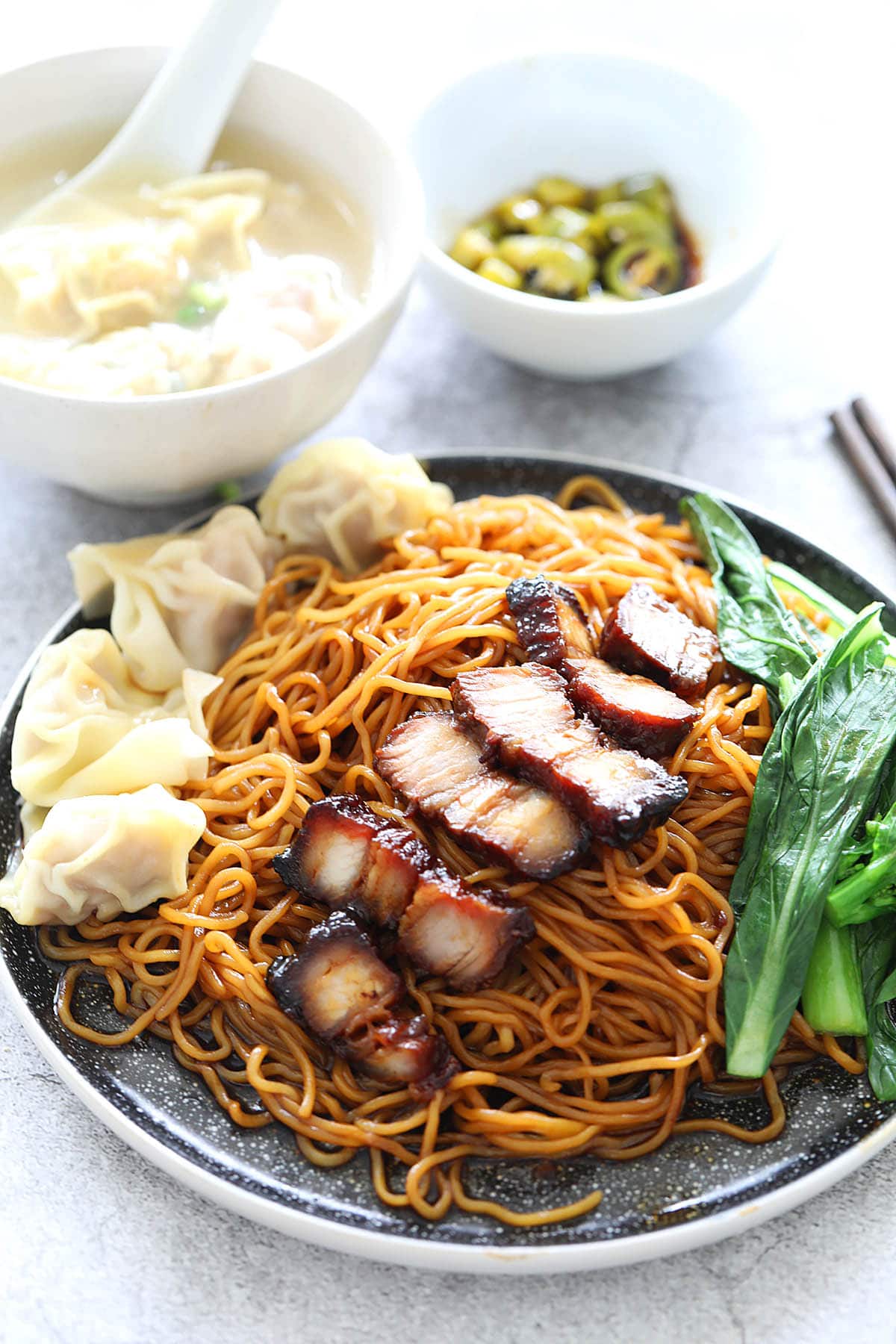 Wonton noodles with dark sauce on a plate.