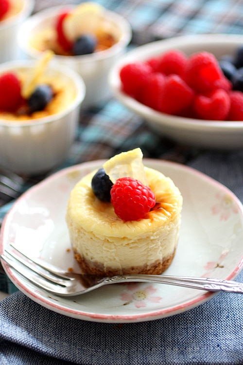 Delicious mini lemon cheesecake topped with berries.
