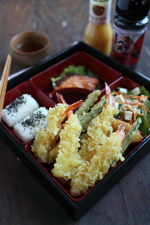 Crispy deep-fried Japanese Shrimp Tempura with tempura dipping sauce in a Japanese lunch bento box.