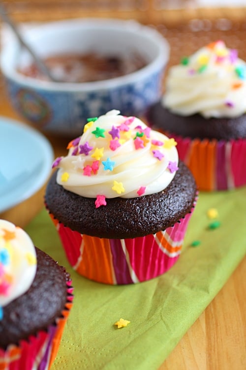 Easy and quick chocolate cupcakes topped with frosting and sprinkles.