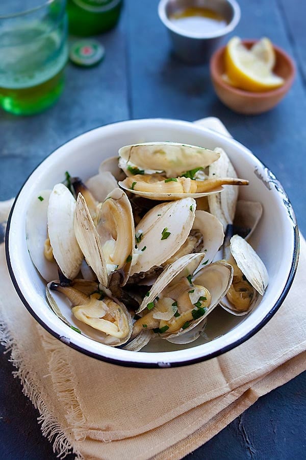 Easy homemade New England steamers (soft shell clams) with garlic herb butter served in a bowl.