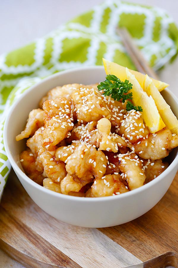 Lemon chicken with zesty and citrusy lemon sauce served in a bowl.