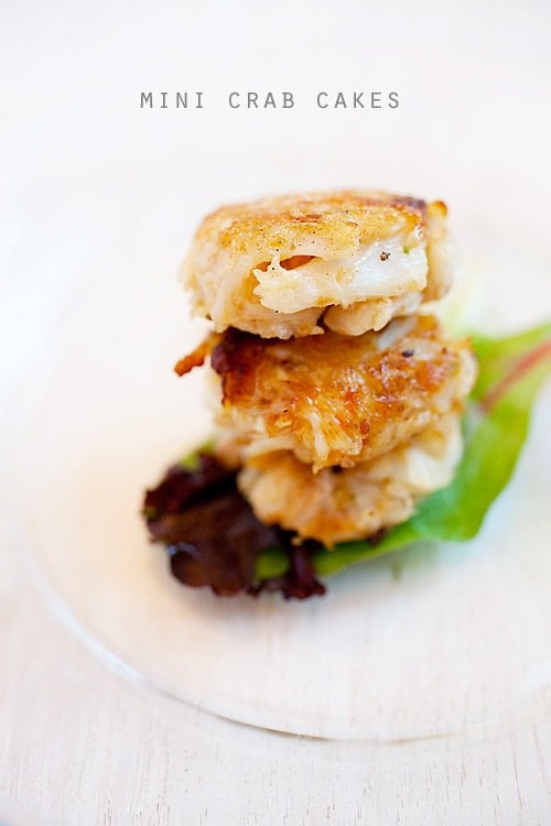 Crab cakes stacked together and served on a plate.