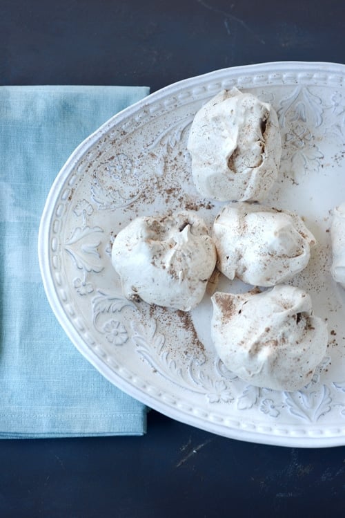 Easy homemade chocolate chip meringue cookies made with chocolate chop and dusted wit cocoa powder.