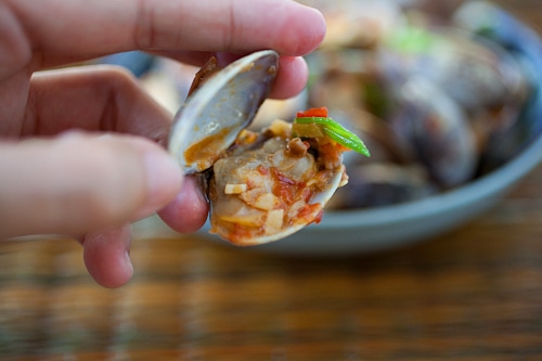 stir fried chili clams held in hand.
