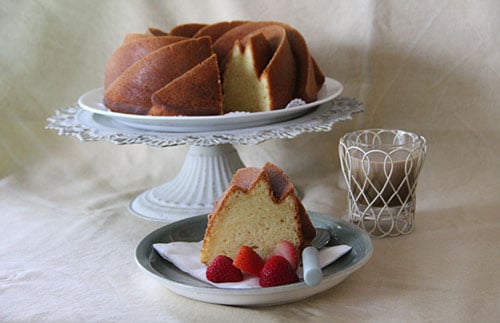 Homemade lemon cream cake sliced and placed on a plate, ready to serve.