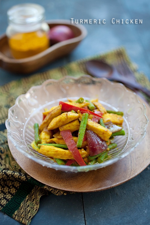 Malaysian style chicken stir fry marinade with turmeric served in a plate.